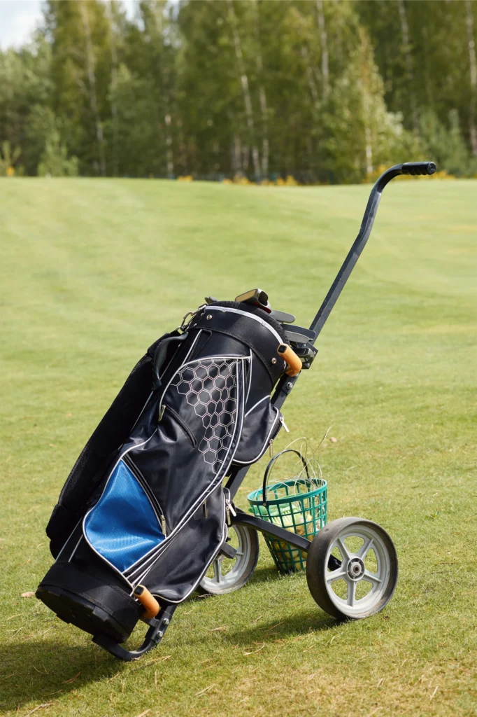 Golf bag on a trolley, ready for a game on a sunny golf course. Ideal for golf enthusiasts.