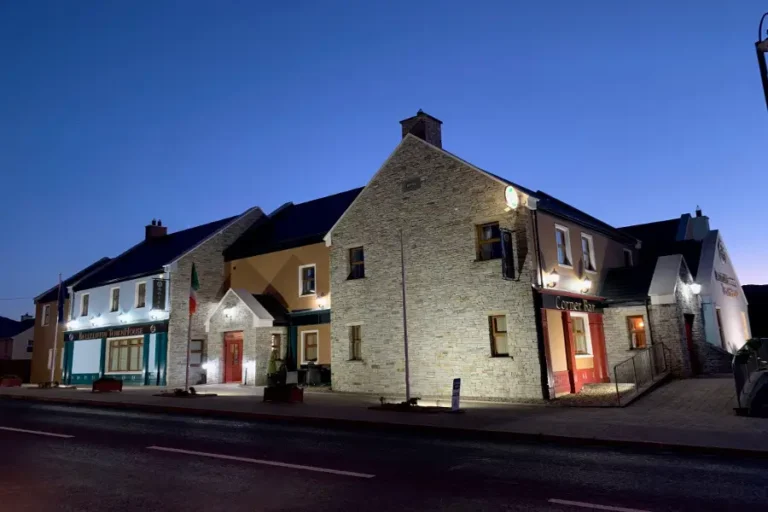 Charming stone pub and restaurant front, beautifully lit at dusk. Ideal for authentic Irish dining.