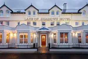 Exterior view of Lake of Shadows Hotel, showcasing elegant architecture and welcoming entrance in Ireland.