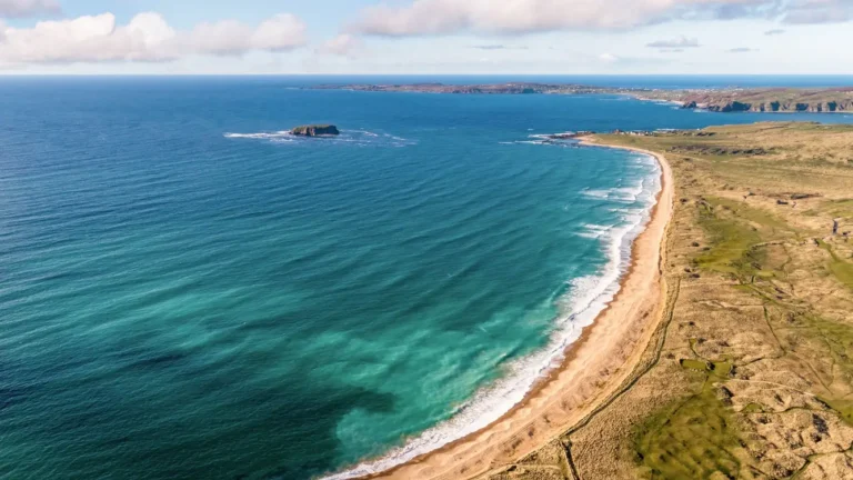 Stunning coastal view of sandy beach and turquoise waters, showcasing Ireland’s beautiful landscape.